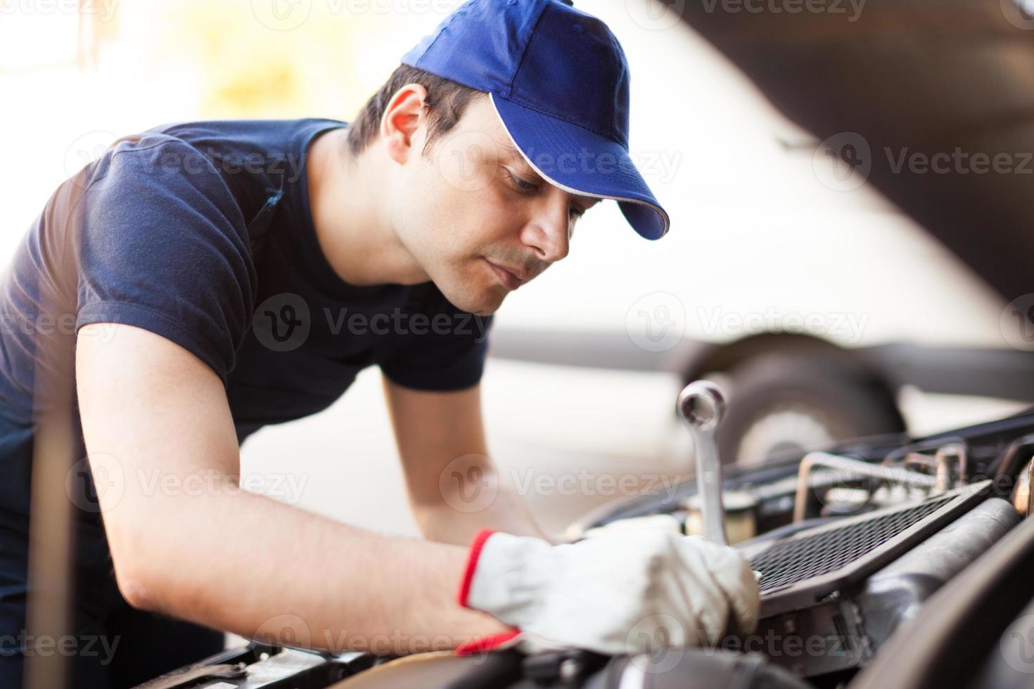 Mechanic working on a car engine photo