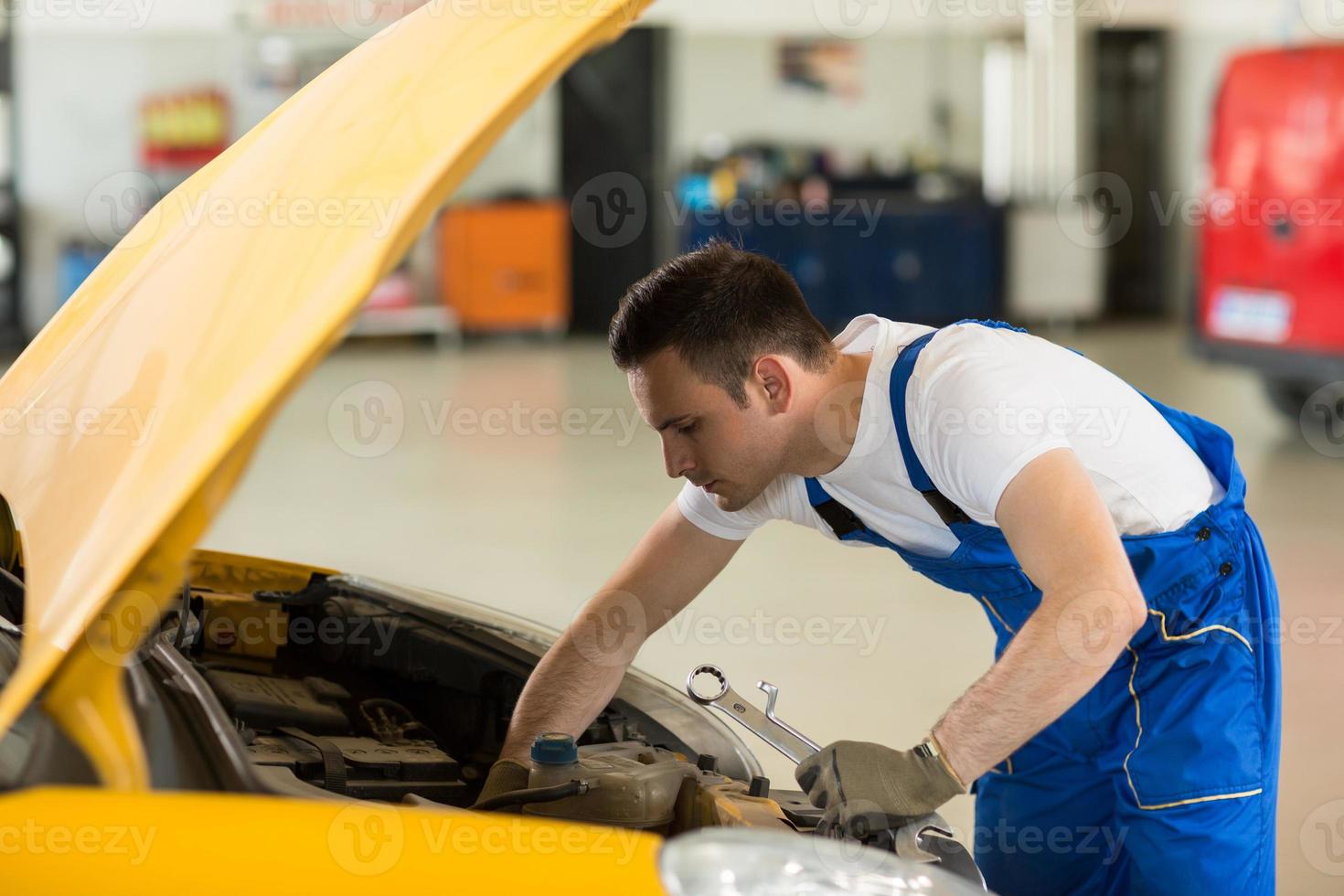 mechanic working on engine photo
