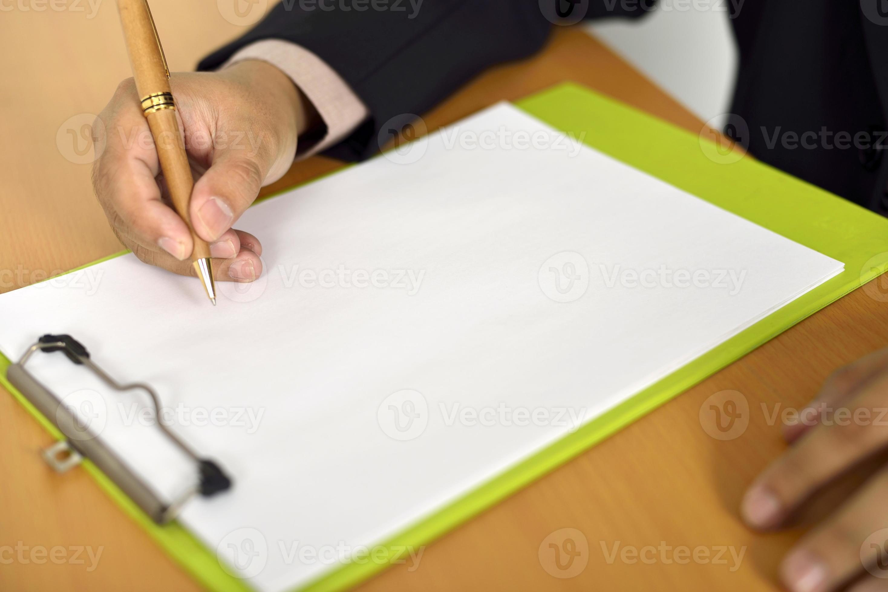 Знаменитость держит белый лист чистый. Ин сидит на листке. Лист бумаги на столе. Держит чистый листок. Деловая женщина с бумажками и улыбкой.