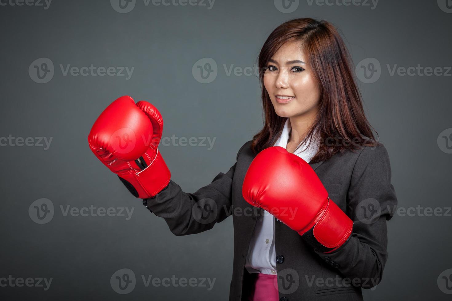 Asian businesswoman with boxing glove photo