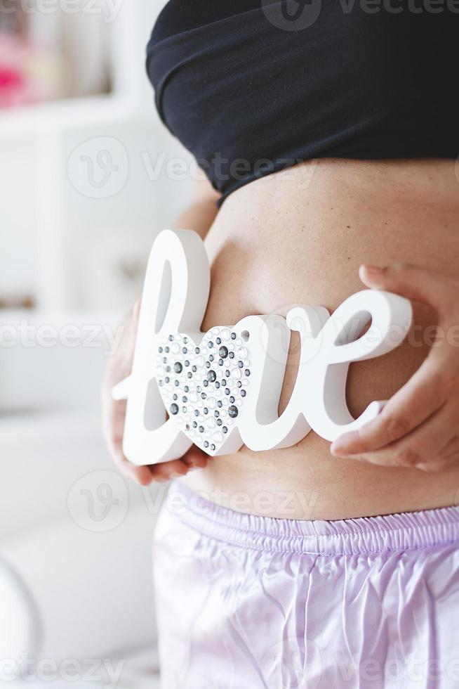 Pregnant Belly with word love photo