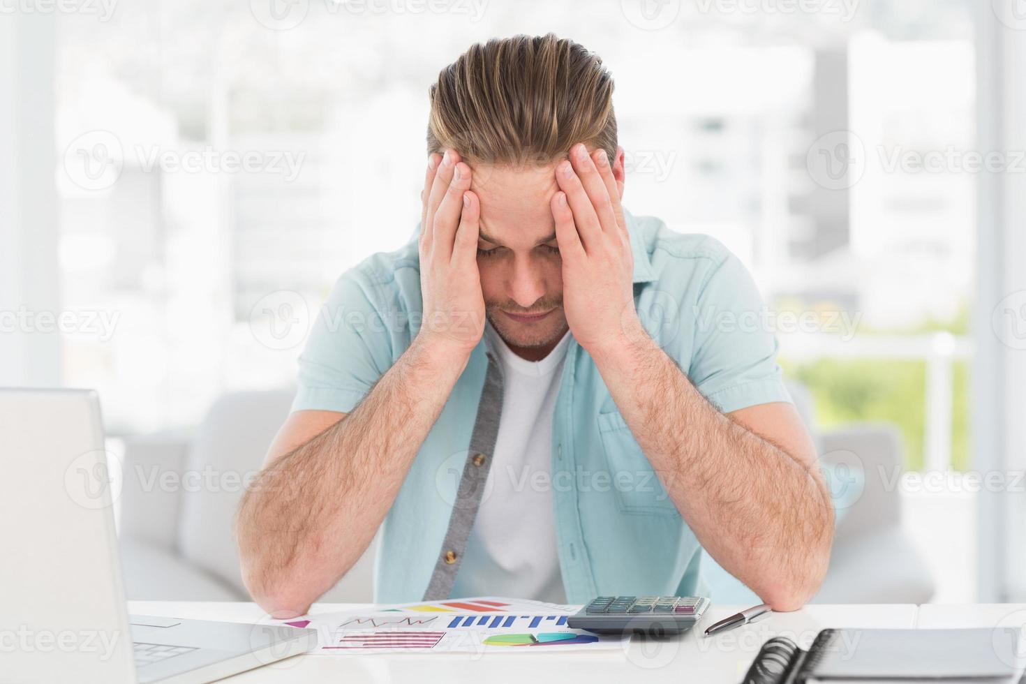 Stressed businessman covering his face photo
