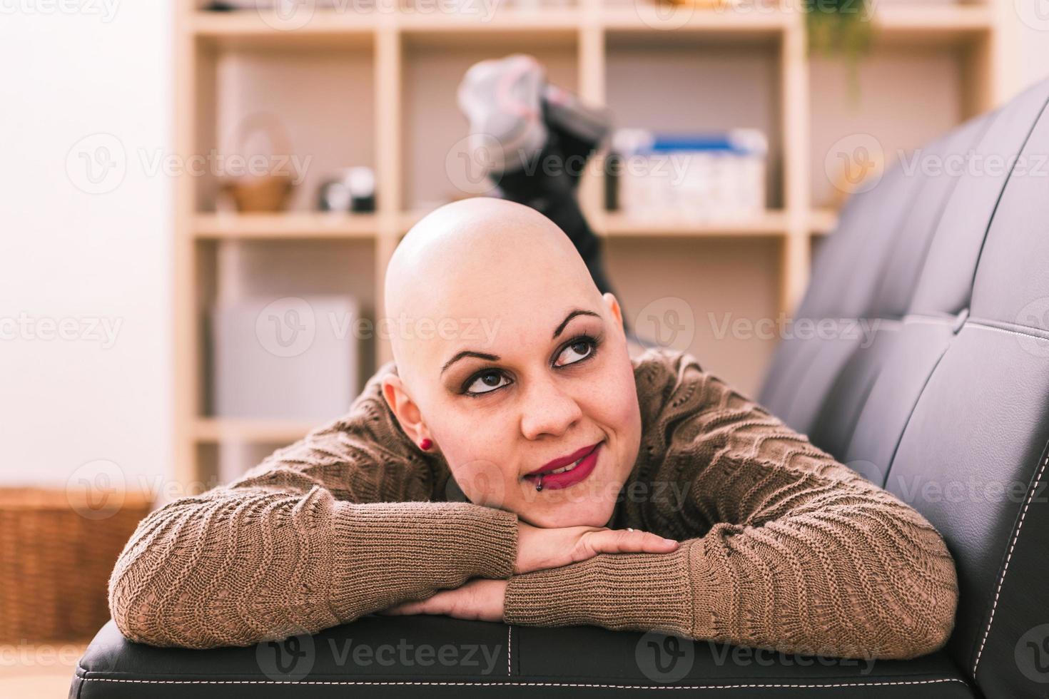 Young woman is overcoming cancer at home photo