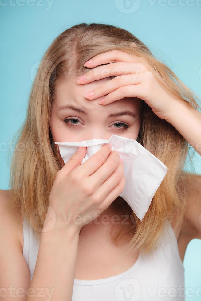 Flu allergy. Sick girl sneezing in tissue. Health photo