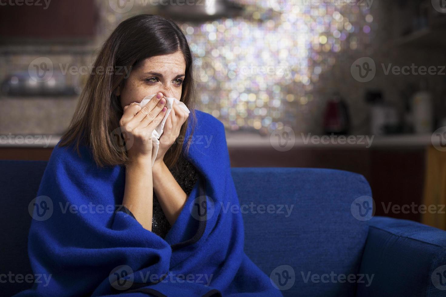 Sick young woman is coughing and blowing photo