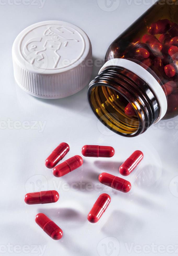 Capsules in an open jar of brown photo