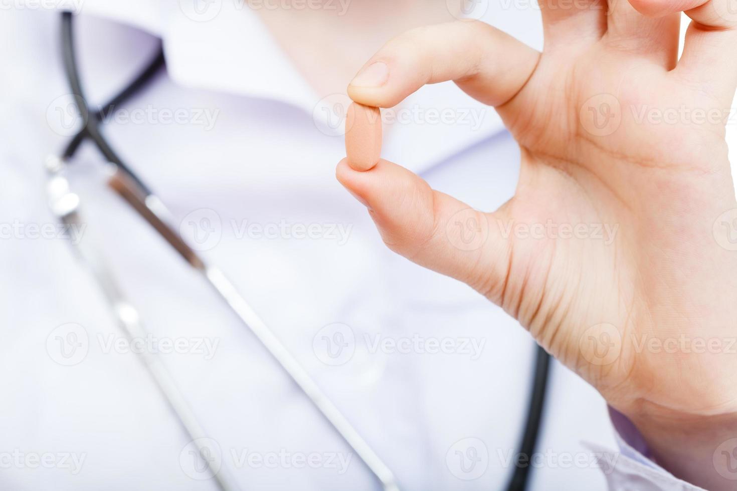 nurse holds drug in fingers photo