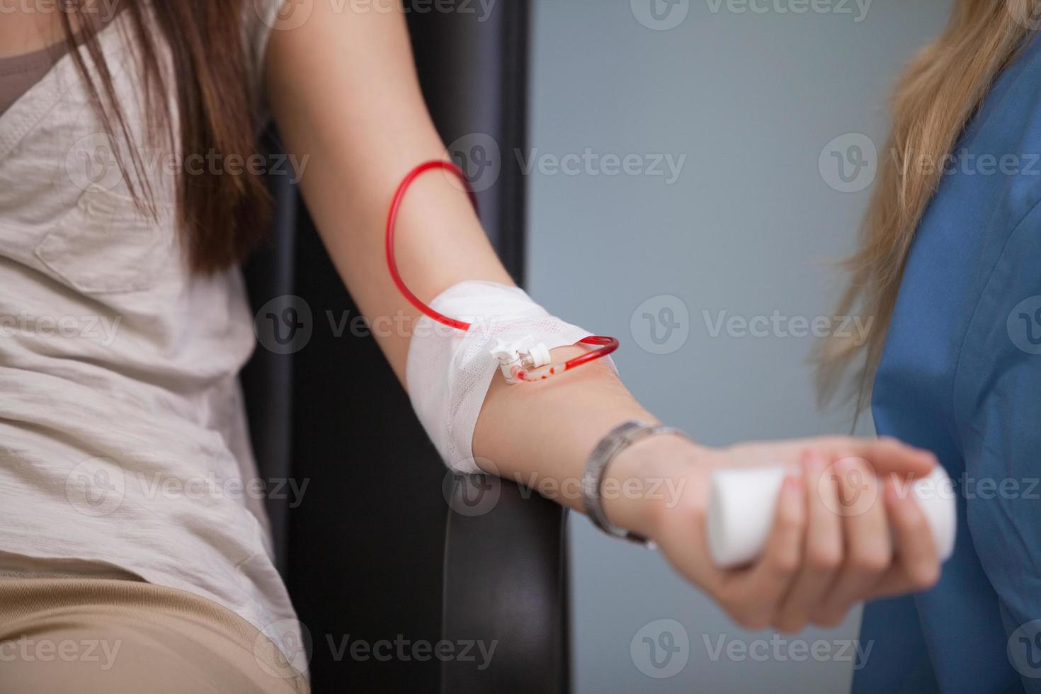 Young woman giving her blood photo