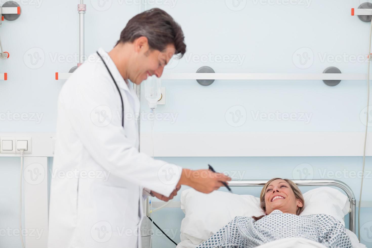 Doctor looking at his chart next to patient photo