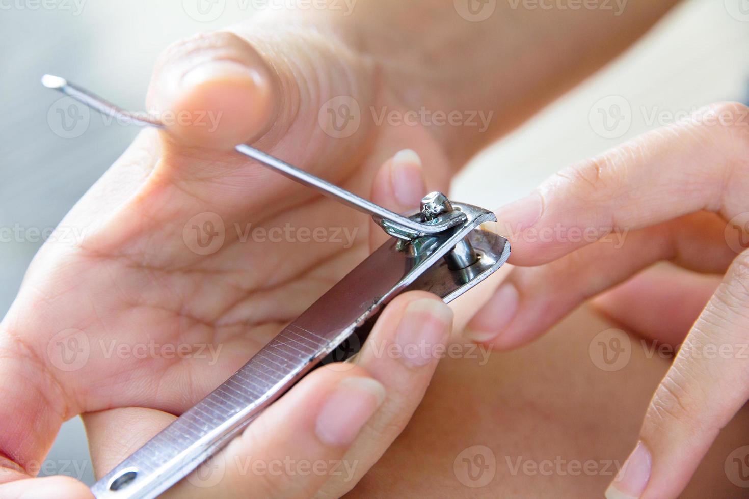 hand manicure with nail clipper photo