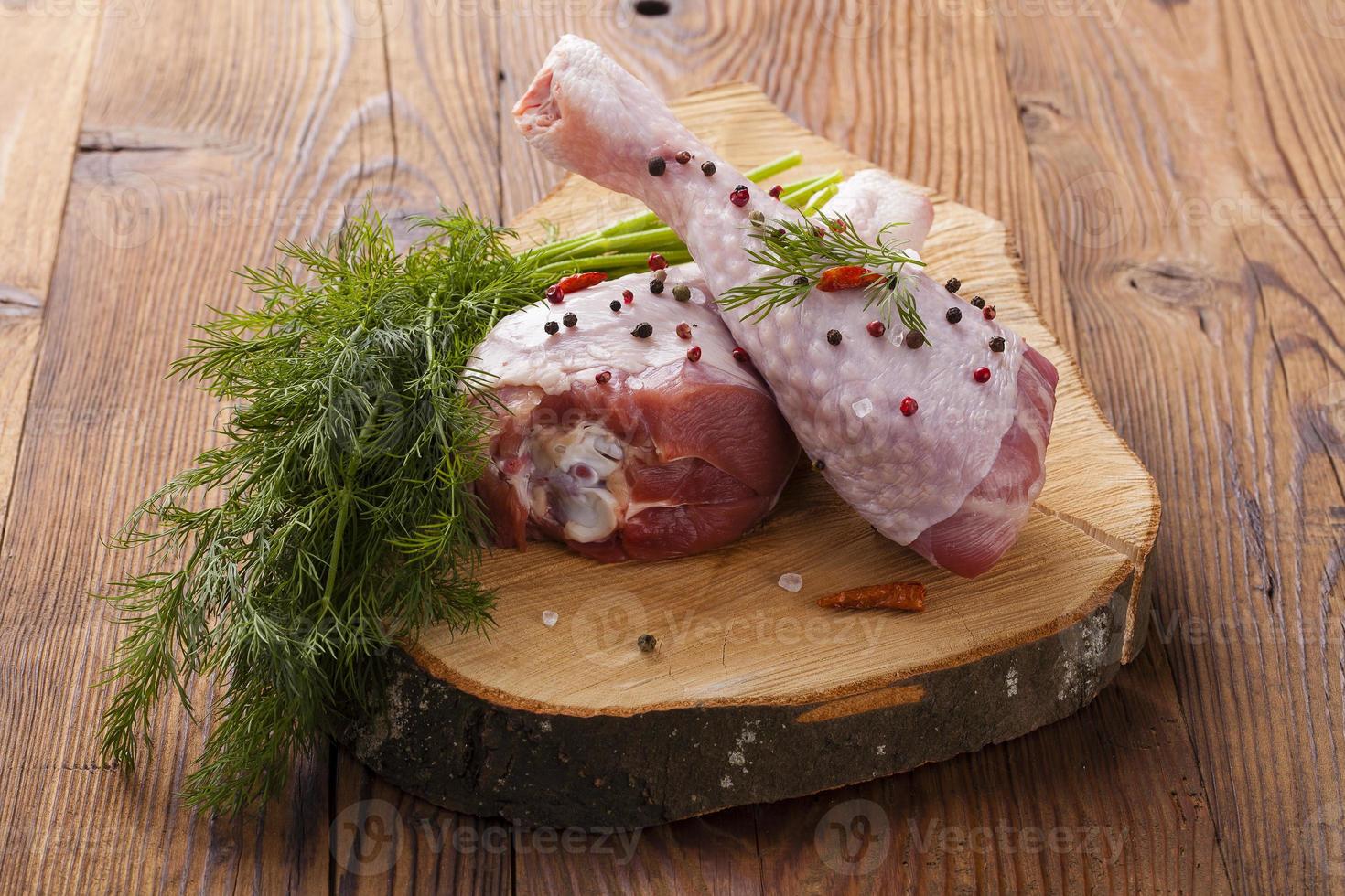Raw turkey thigh with spices photo