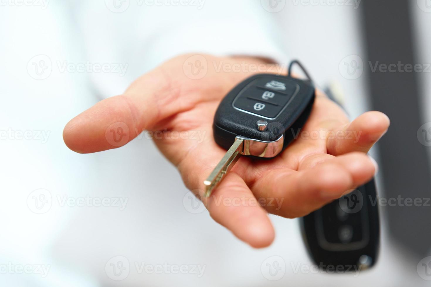 Car Keys. Seller hand giving keys photo