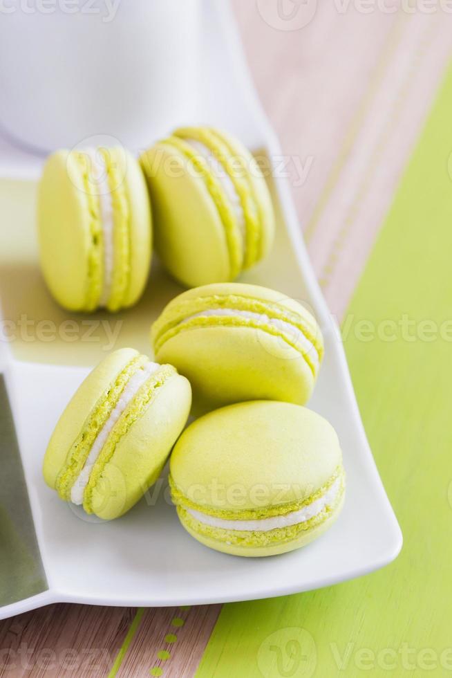 Green macaroons on a square plate. Top view photo