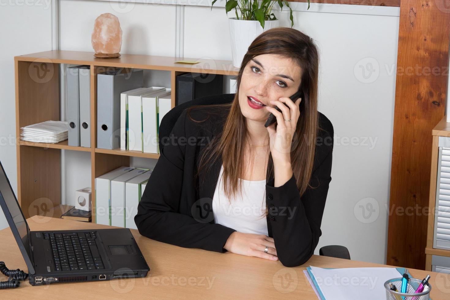feliz empresaria inteligente en el teléfono en la oficina brillante foto