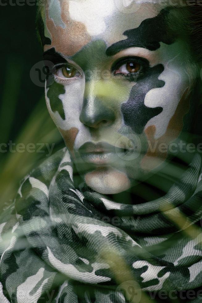 Beautiful young fashion woman with military style clothing and face photo