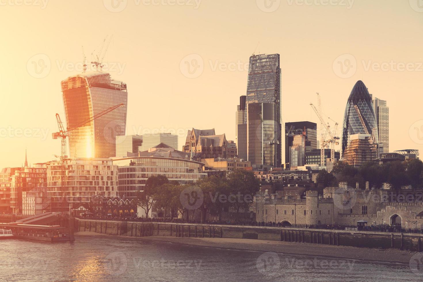 Tower of London and Modern Skyscrapers on Background at Sunset photo