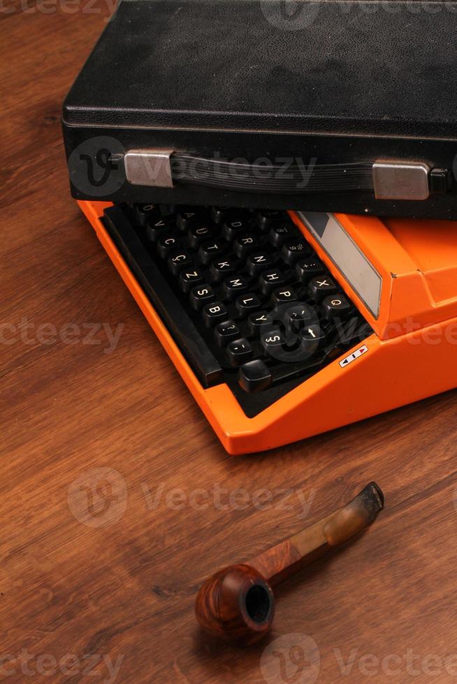 máquina de escribir vintage naranja en la madera foto