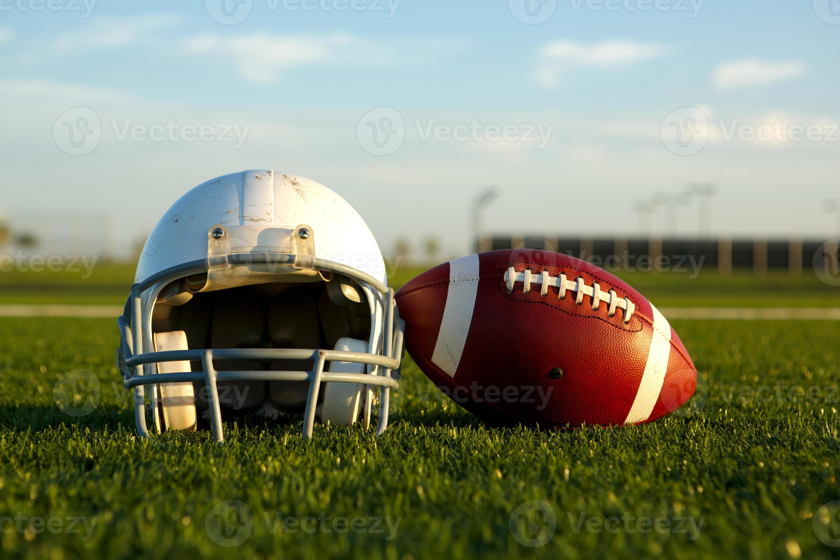 Football and Helmet on the Field photo