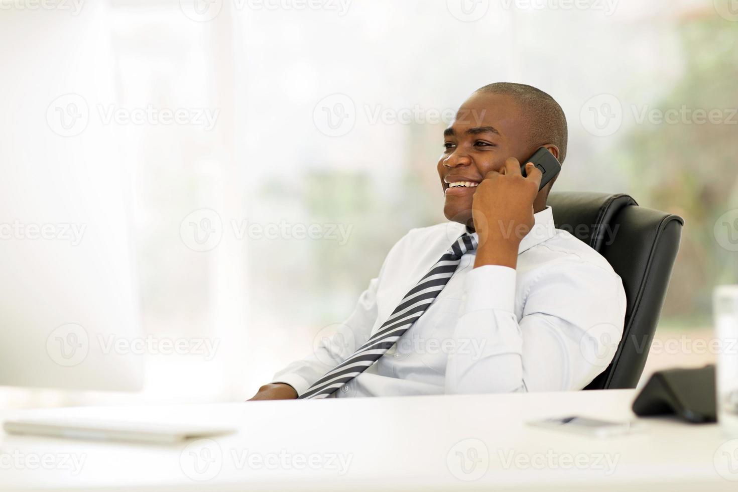 african business executive talking on landline photo