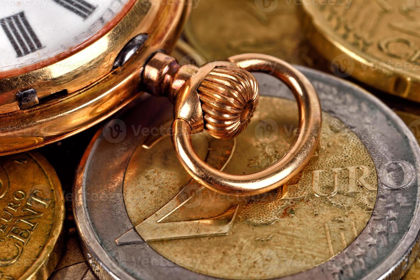 Euro coins and pocket watch photo