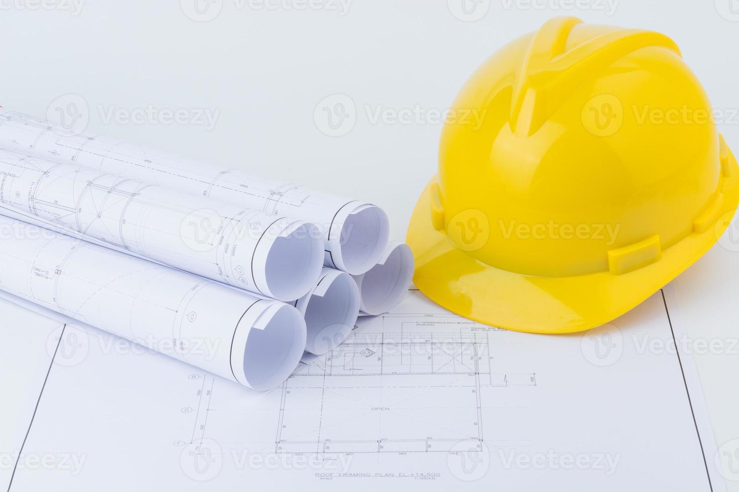 Yellow safety helmet and plan drawing photo