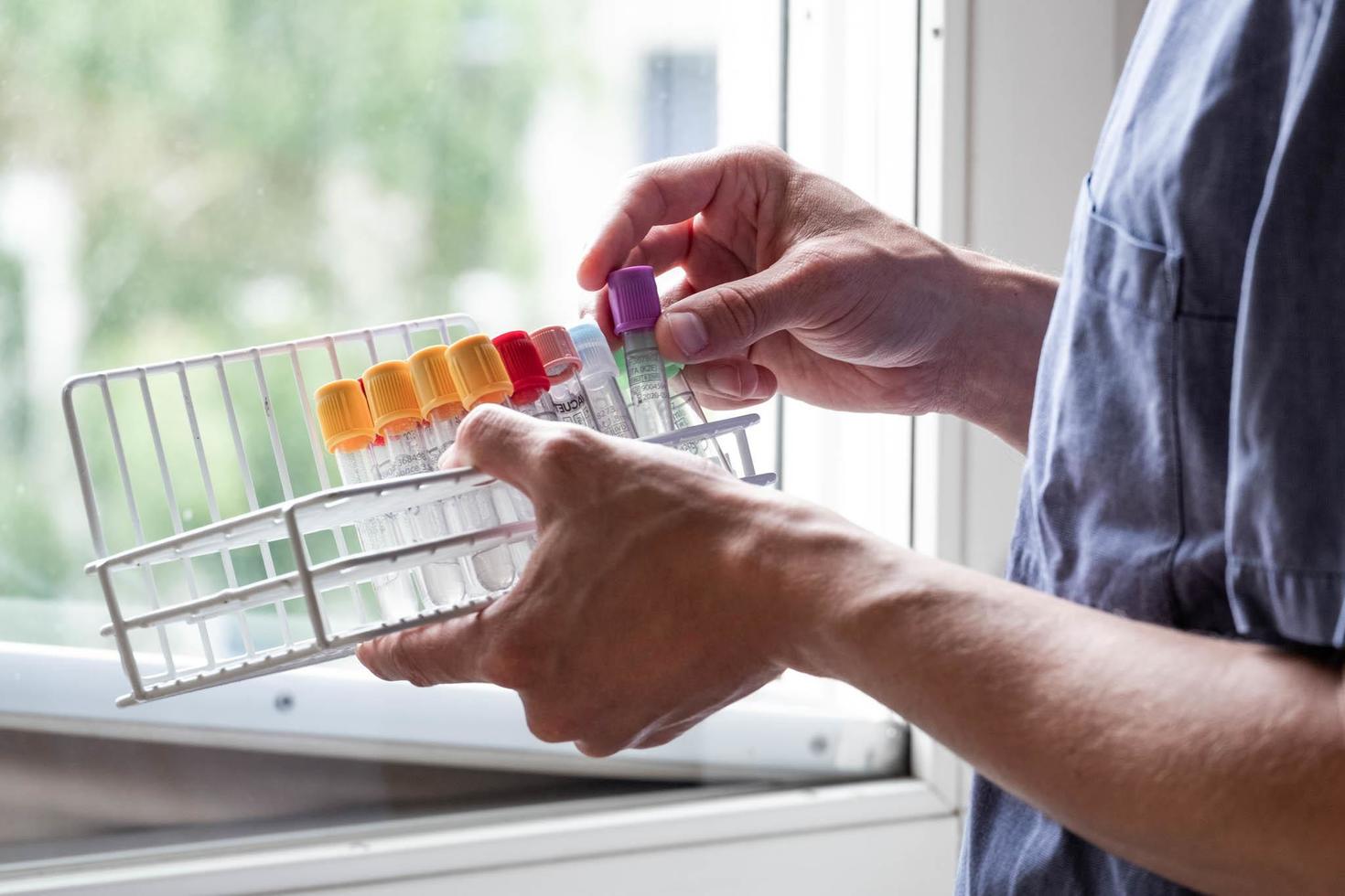 A nurse seen holding vials in medical office  photo