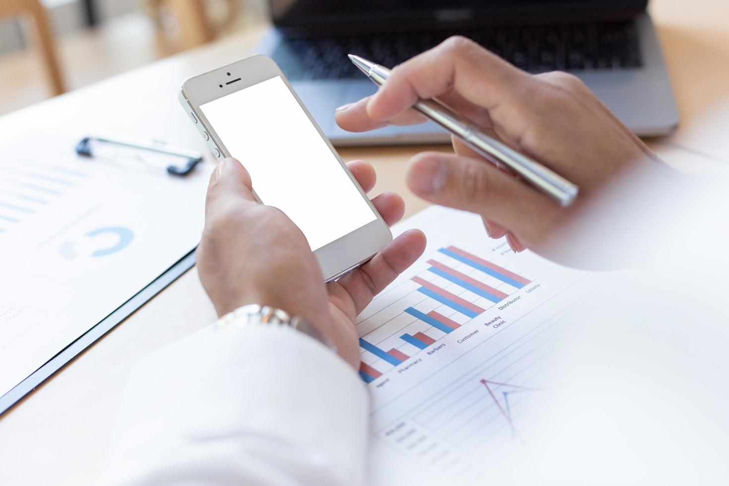 Businessman using mobile phone at work desk photo