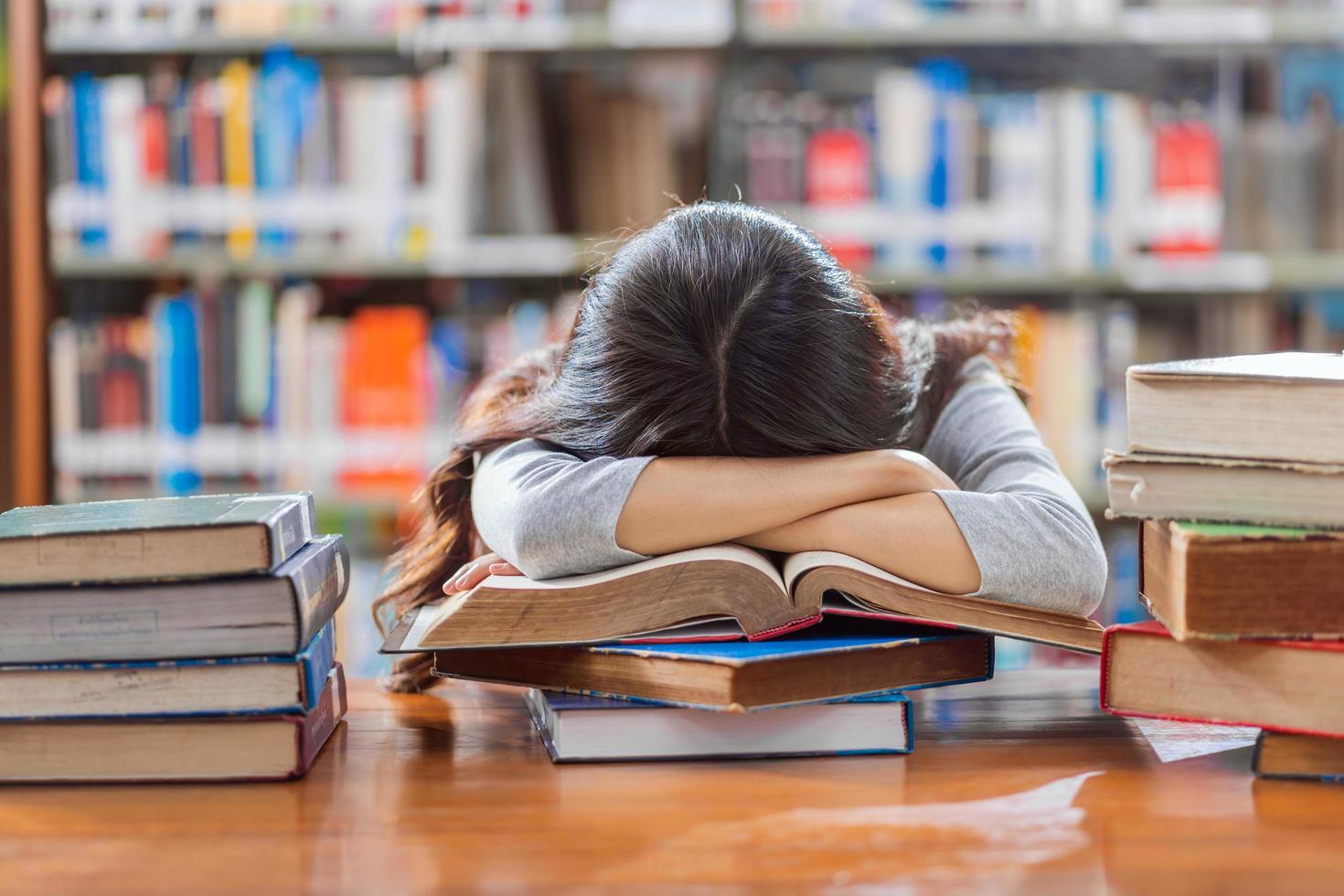 A young student take a study break at a library photo