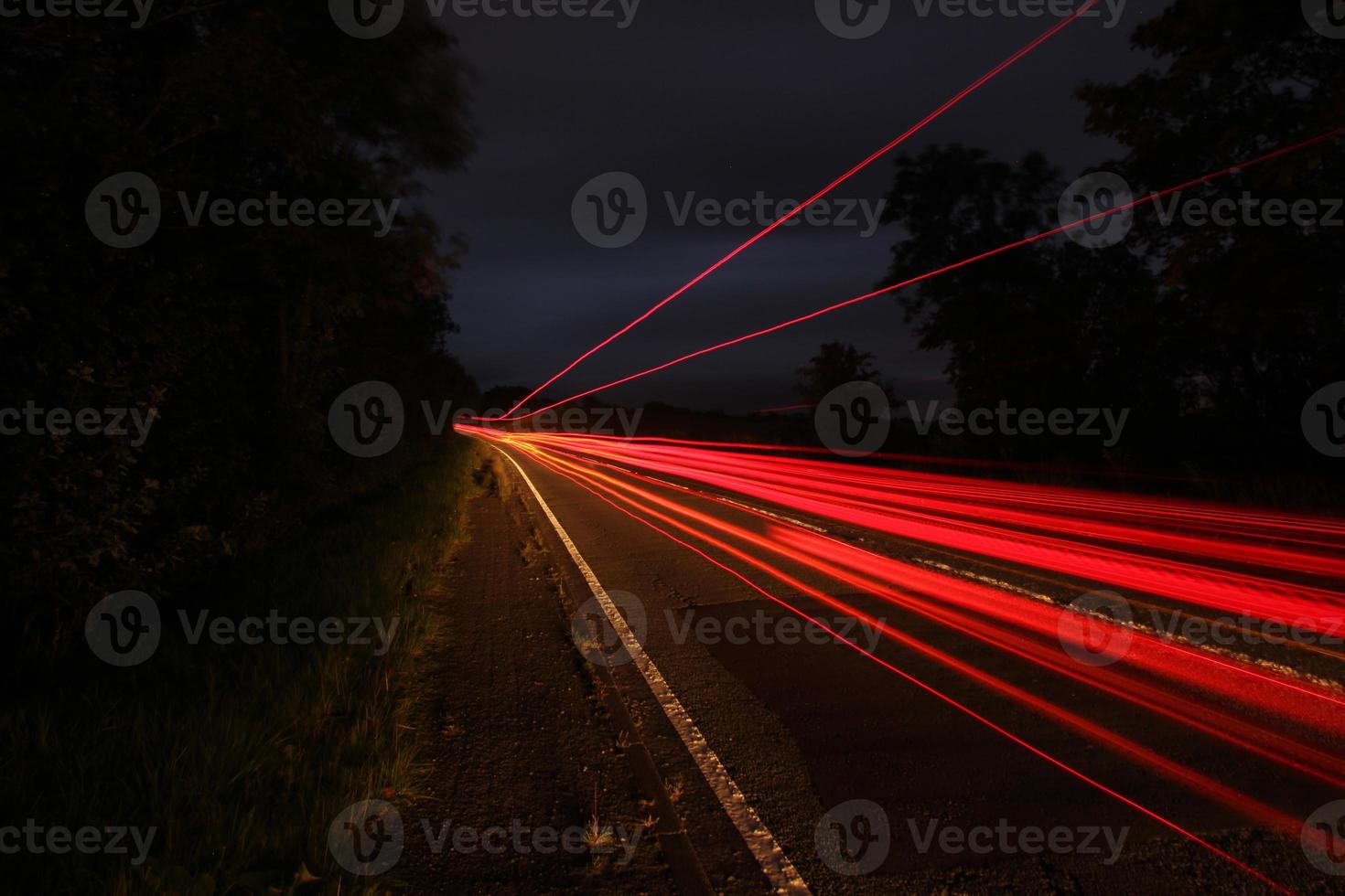 Long exposure vehicle lights country road photo
