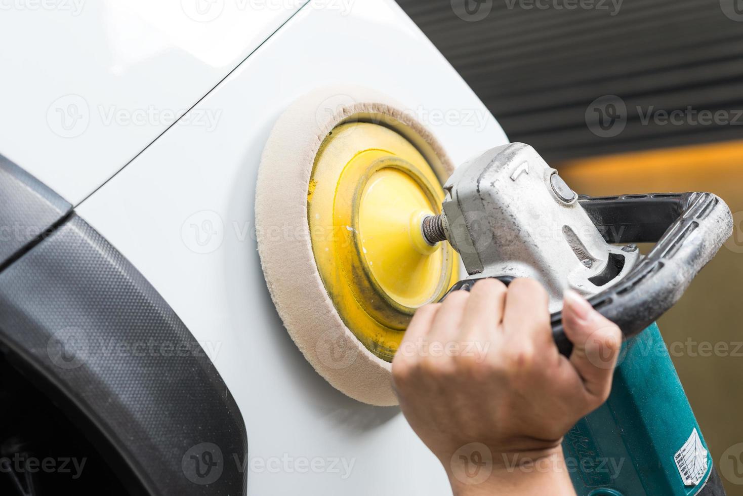 Car polishing series : Worker waxing white car photo