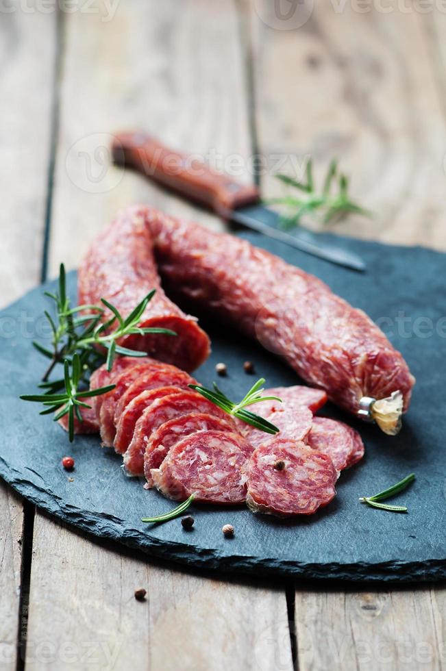 Salami on the wooden table photo