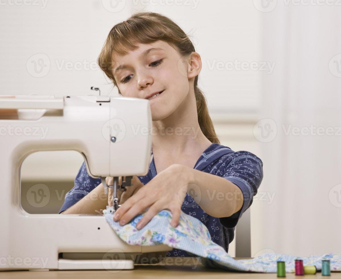 Girl Using Sewing Machine photo