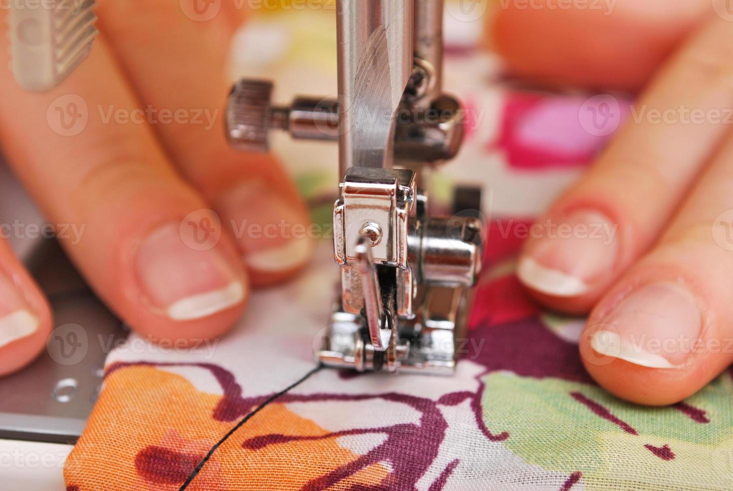 Woman seamstress work on the sewing-machine photo