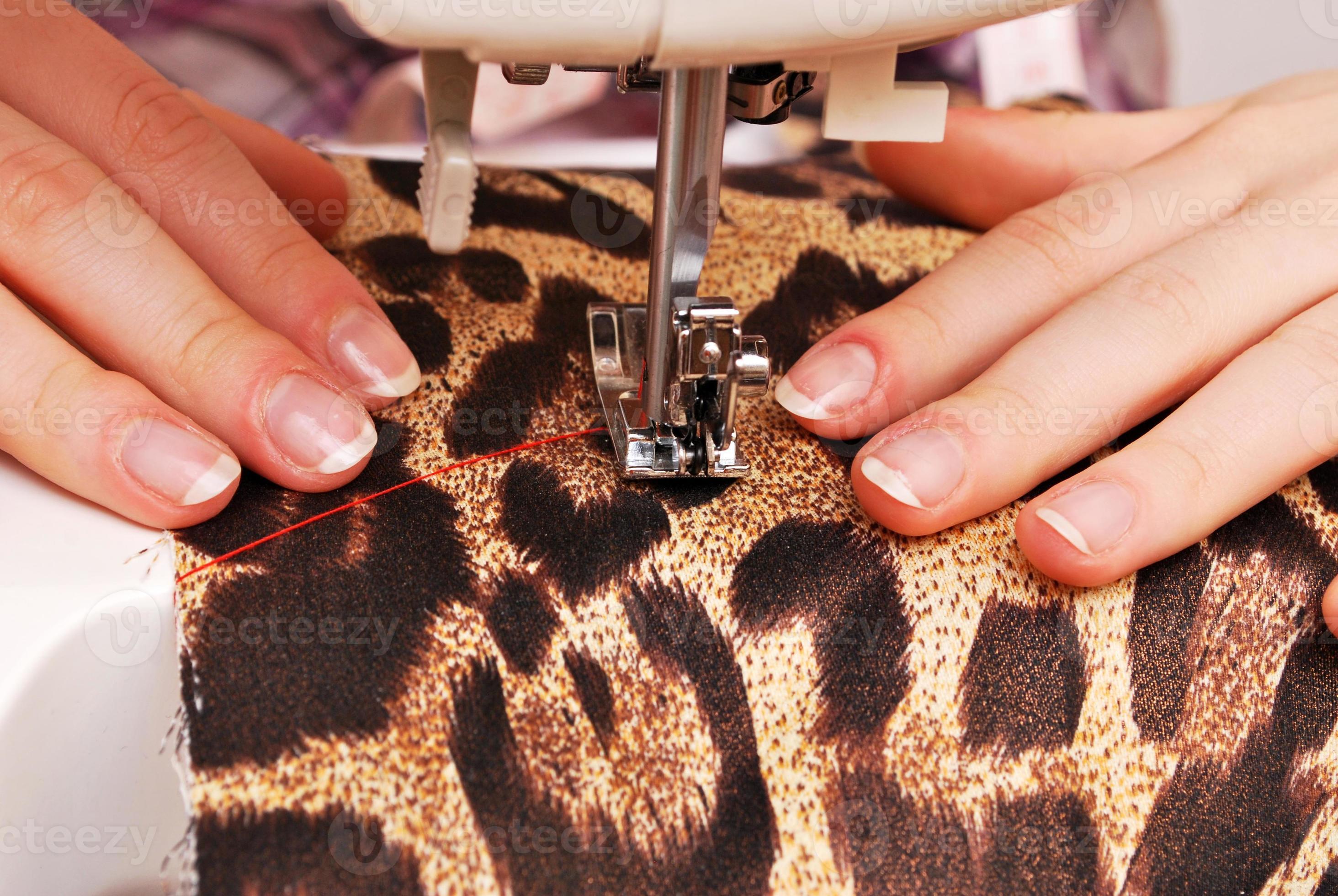 Woman seamstress work on the sewing-machine photo