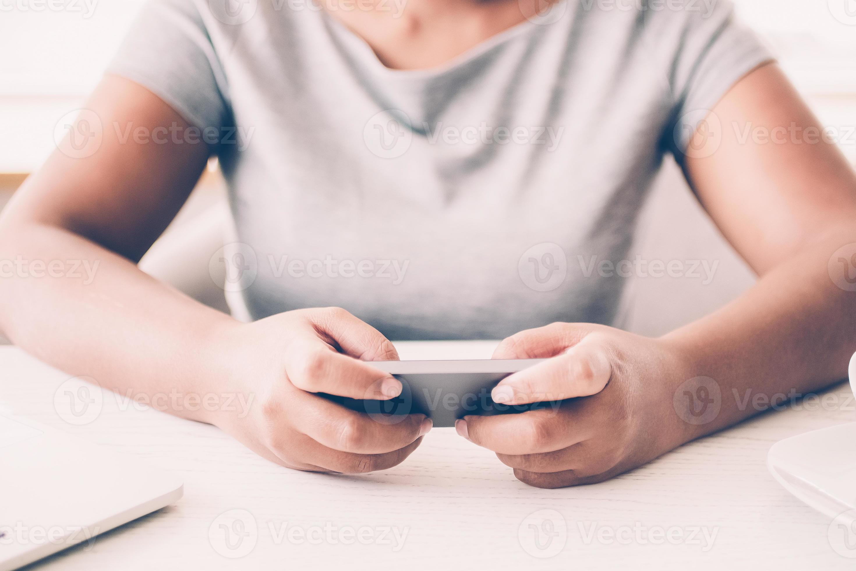 Close Up Of Woman Texting Message At Table Smiling Female Gamer Using Smartphone To Play Video Game Businesswoman Sitting At Desk With Laptop And Coffee Cup Technology Concept Stock Photo Close Up Of Woman Texting Message At Table Smiling Female Gamer Using Smartphone To Play Video Game Businesswoman Sitting At Desk With Laptop And Coffee Cup Technology Concept Stock Photo