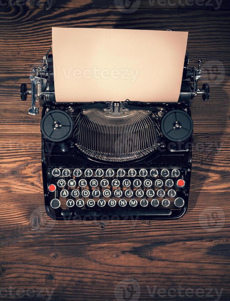 Retro typewriter on wooden planks photo