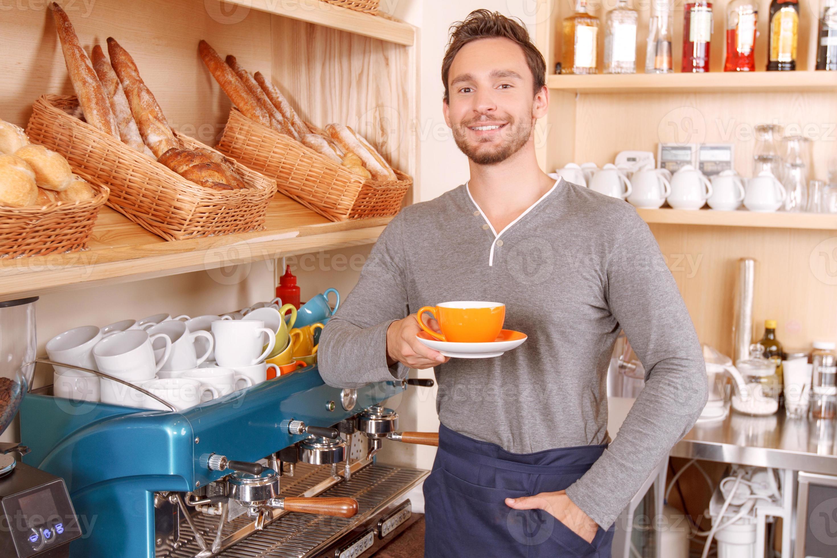 Handsome cafeteria worker with cup of coffee 1178689 Stock Photo at
