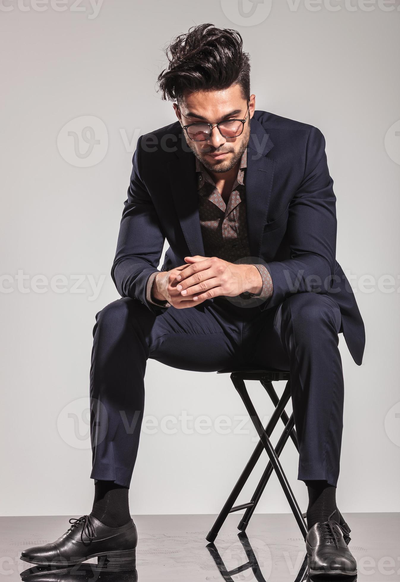 business man sitting on chair and looking down 1179604 Stock Photo at