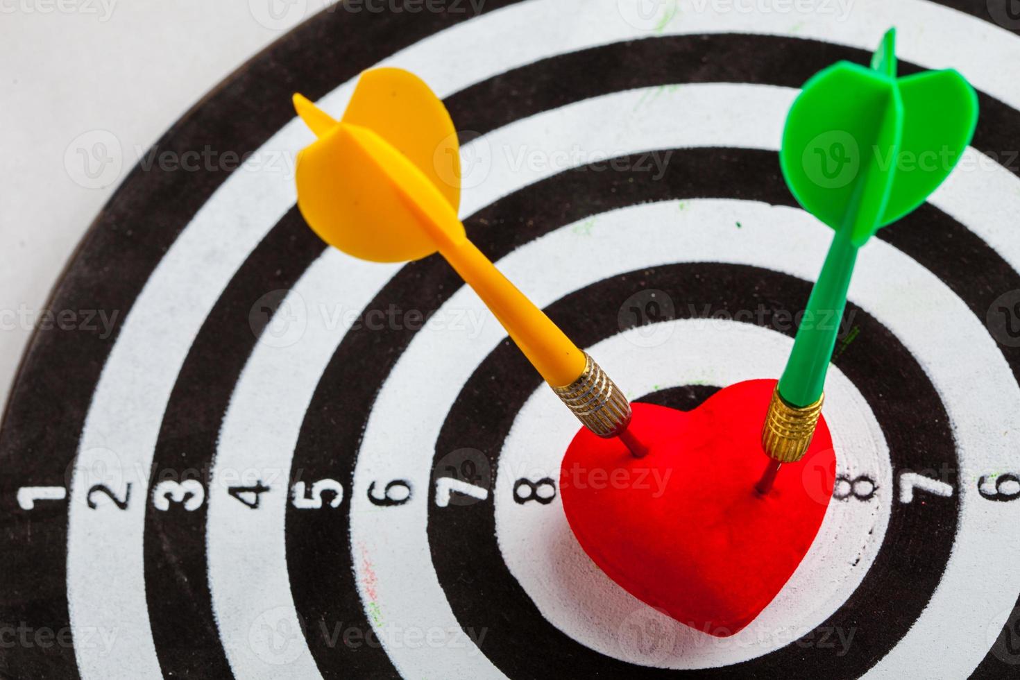Black white target with darts in heart love as bullseye photo