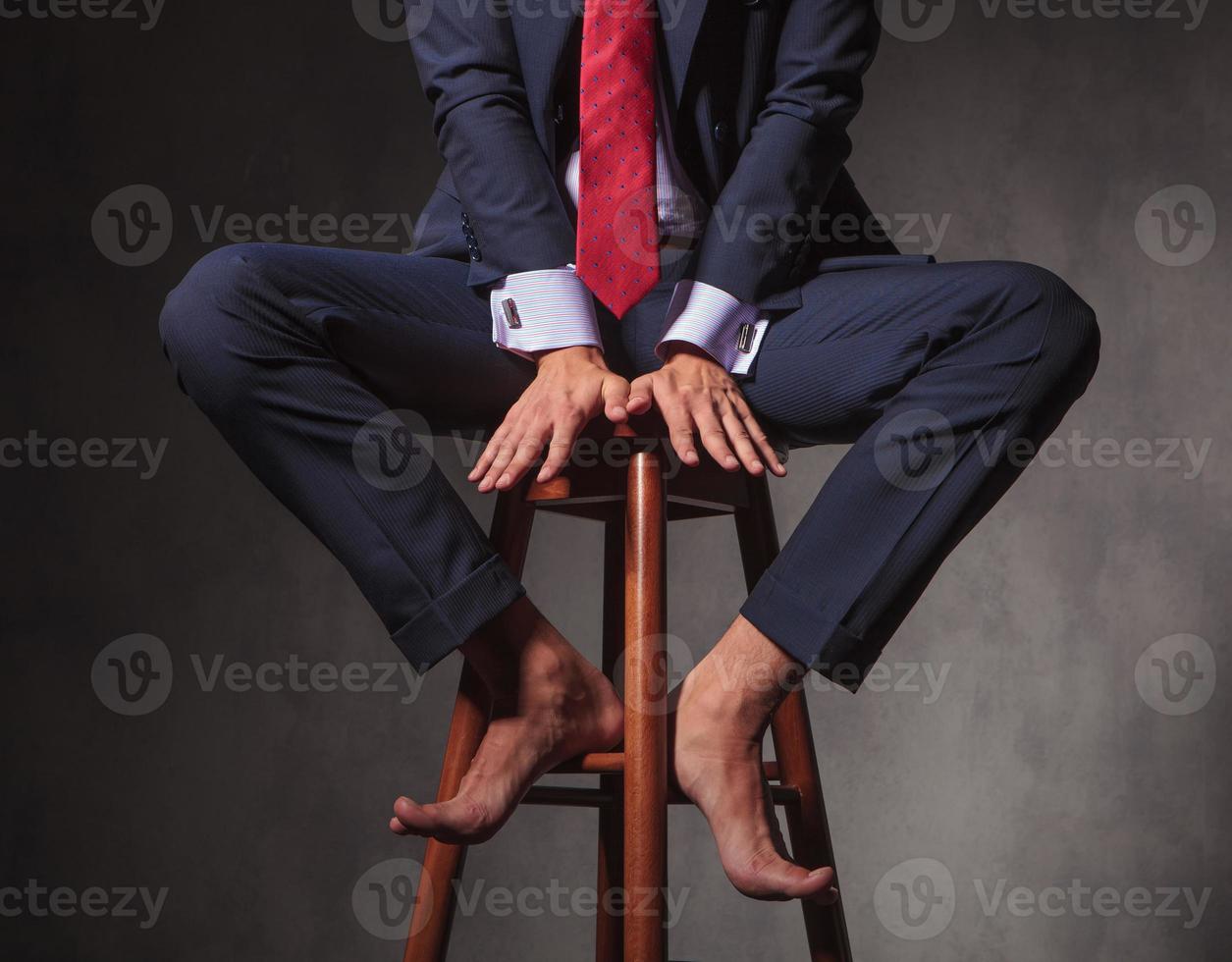 Barefoot business man sitting on a stool 1181421 Stock Photo at Vecteezy