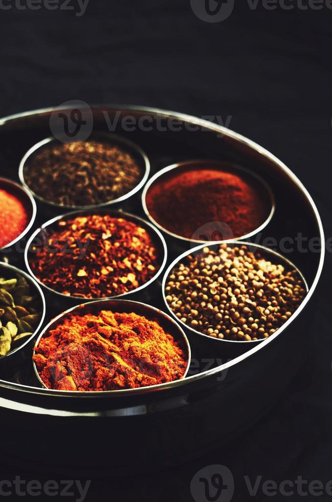 Set of traditional indian spices in metal bowls photo