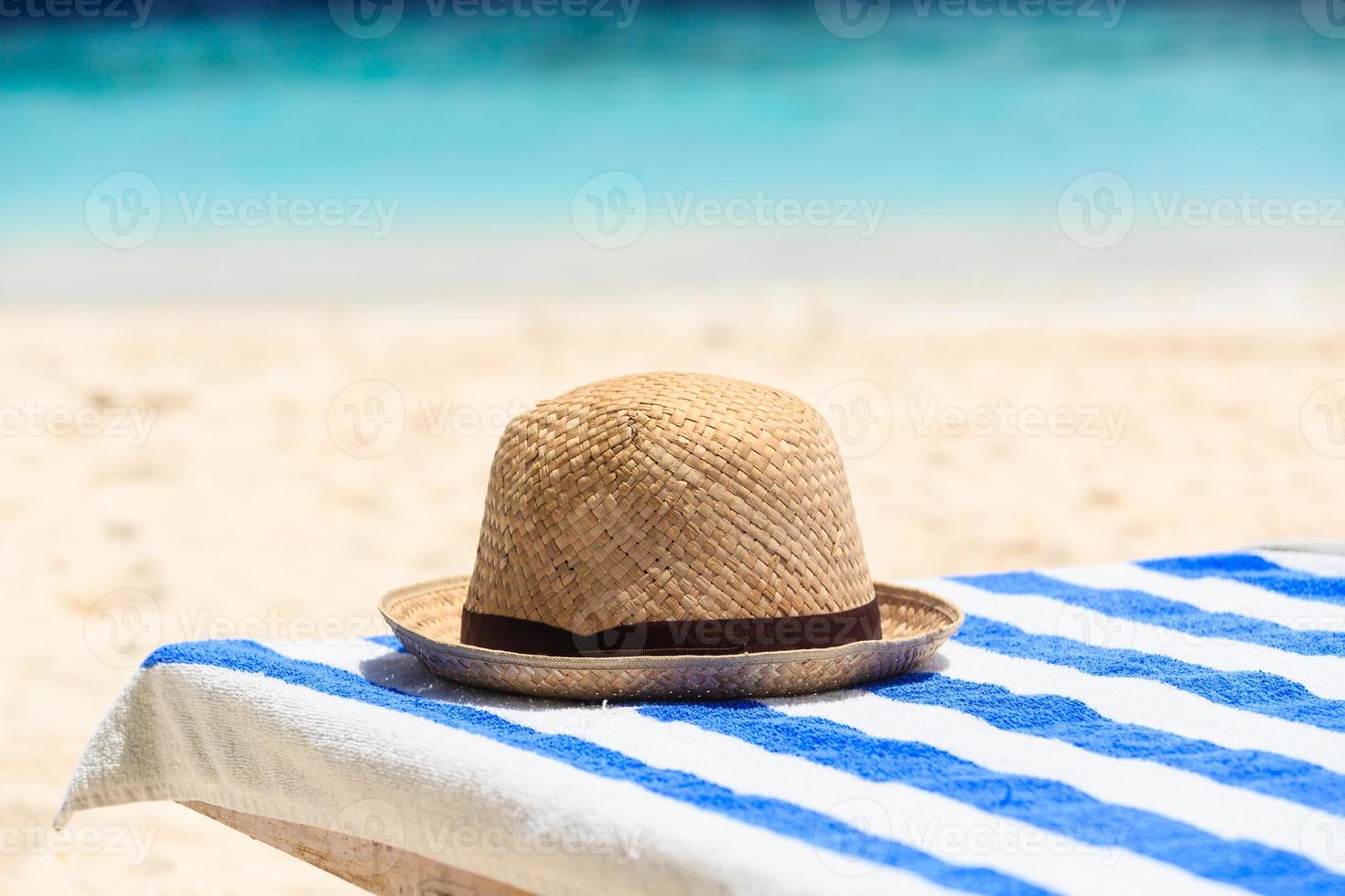 hat on tropical beach vacation photo
