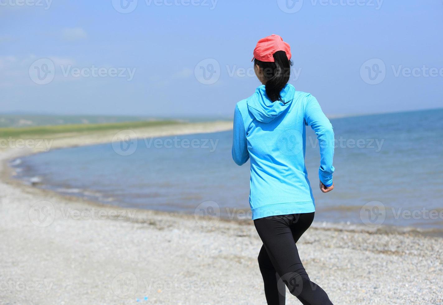 Runner athlete running on seaside photo
