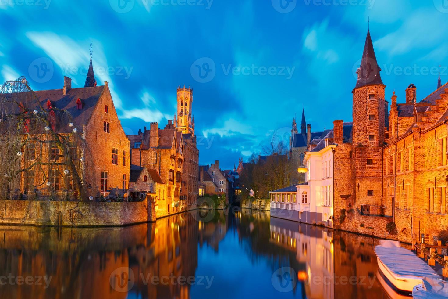 Cityscape with Belfort from Rozenhoedkaai in Bruges at sunset photo
