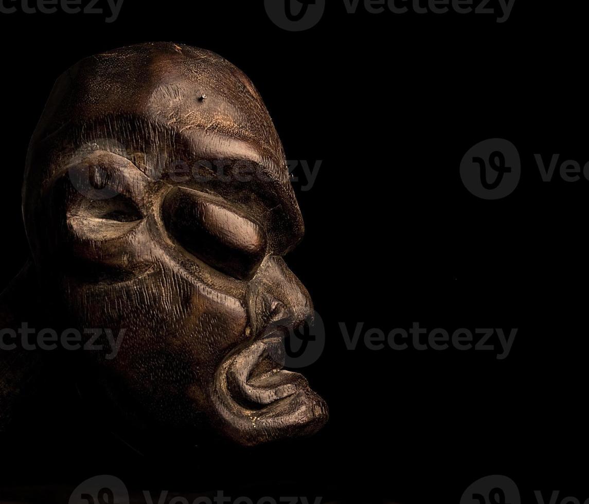 African mask over black background photo