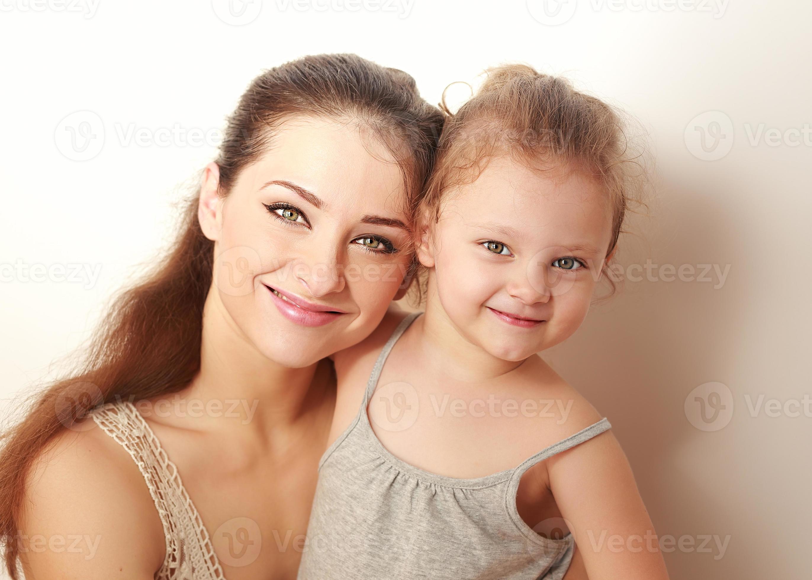 Beautiful Smiling Mother And Small Happy Daughter Cuddling 1217090 