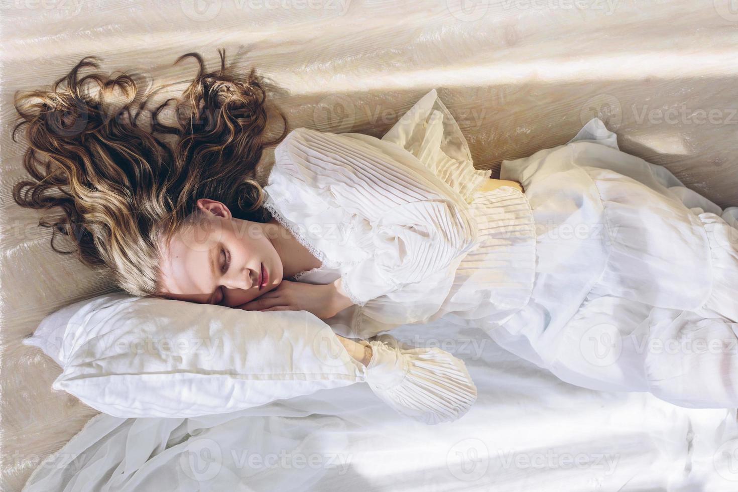 Beautiful woman with long hair sleeping in sun light photo