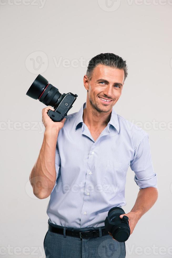 Handsome photographer holding camera photo