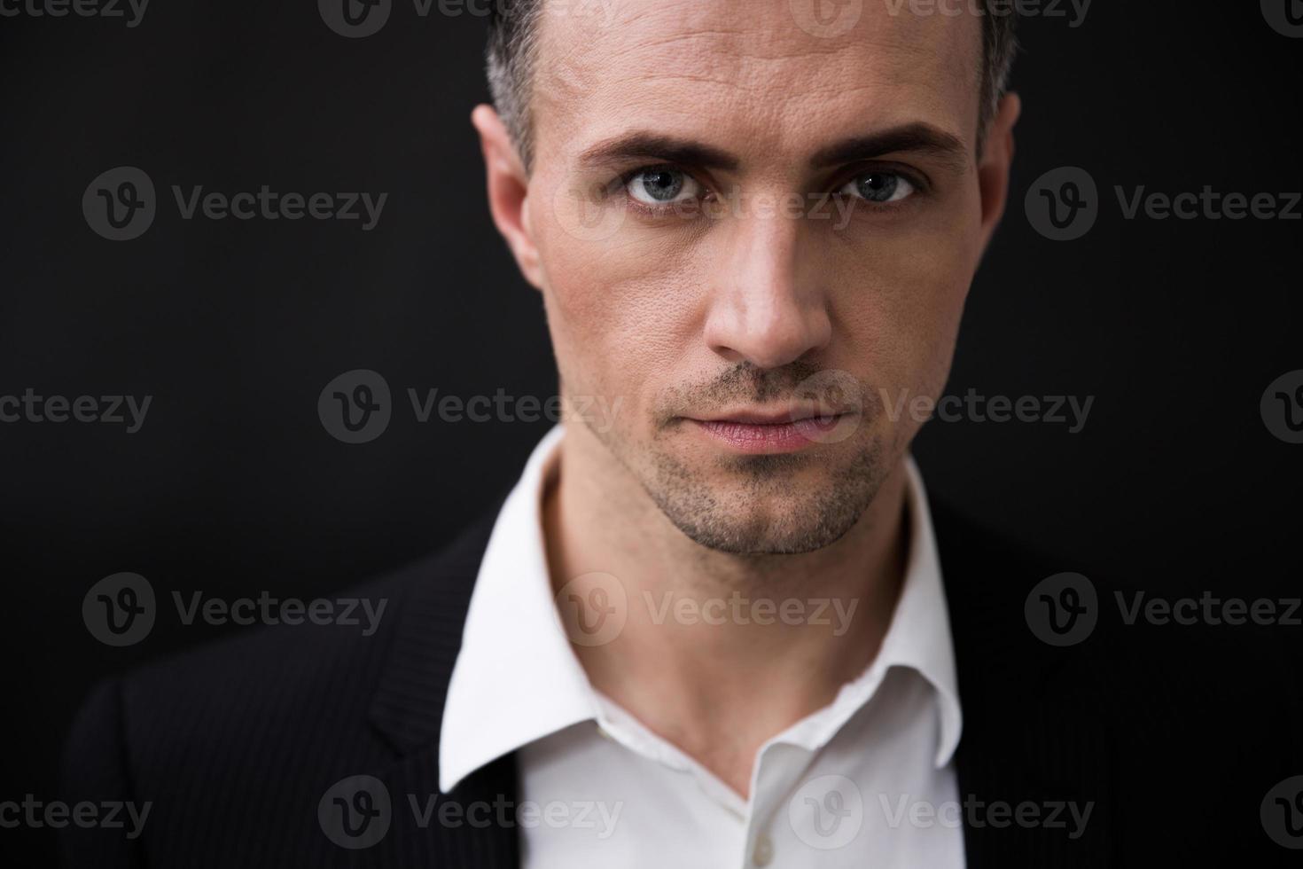Confident businessman looking at camera photo