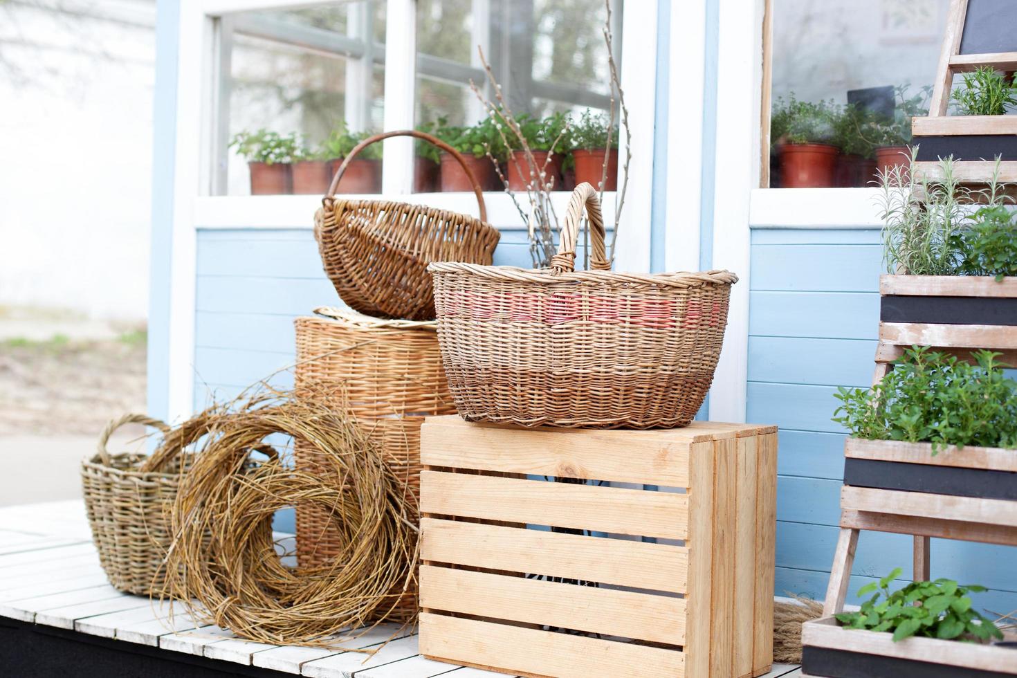 Wicker baskets sit on the porch a blue country house photo